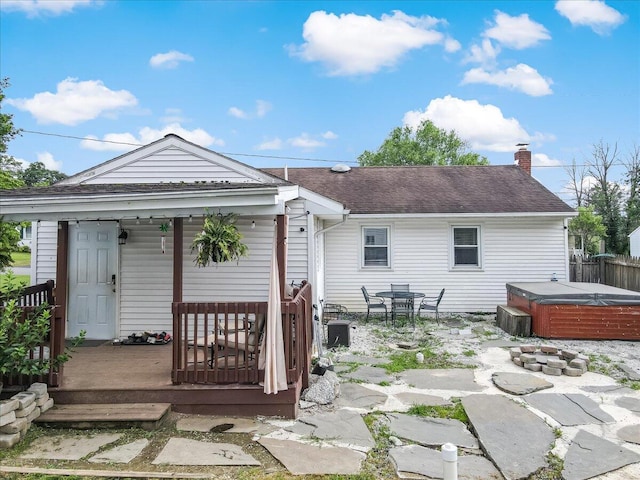 489 Sportsman Club Rd, Nazareth, PA 18064 - rear view of house featuring a hot tub, a shingled roof, a chimney, a patio, and a porch
