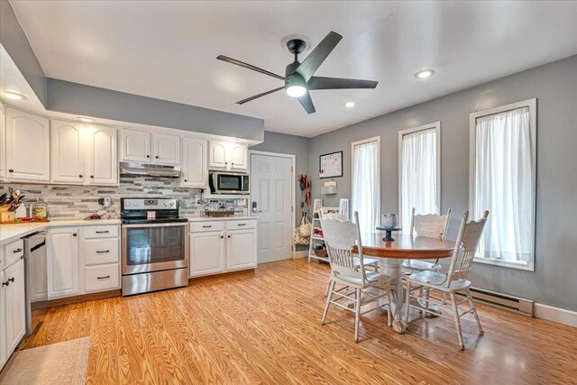 489 Sportsman Club Rd, Nazareth, PA 18064 - kitchen featuring stainless steel appliances, under cabinet range hood, ceiling fan, white cabinetry, and light wood finished floors
