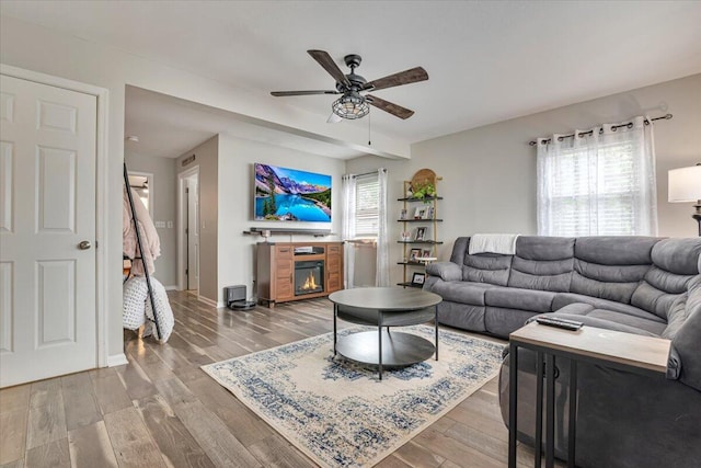 489 Sportsman Club Rd, Nazareth, PA 18064 - living area featuring a glass covered fireplace, ceiling fan, and wood finished floors