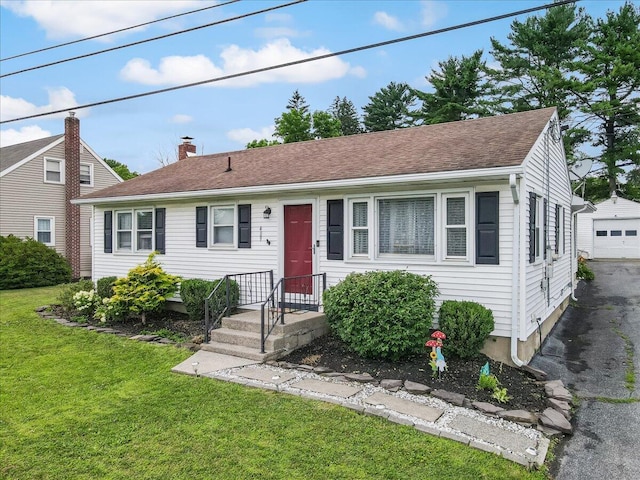 489 Sportsman Club Rd, Nazareth, PA 18064 - view of front of home with a front lawn, asphalt driveway, an outdoor structure, a chimney, and a garage