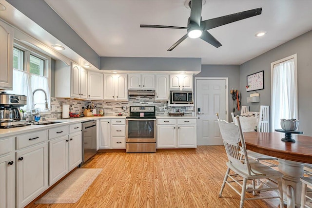 489 Sportsman Club Rd, Nazareth, PA 18064 - kitchen featuring stainless steel appliances, under cabinet range hood, a ceiling fan, white cabinetry, and light countertops