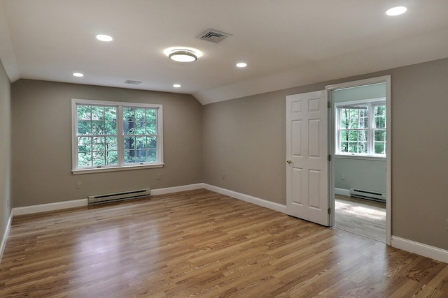 102 Crest Cir E, Stroudsburg, PA 18301 - empty room with baseboard heating, plenty of natural light, lofted ceiling, light wood-type flooring, and recessed lighting