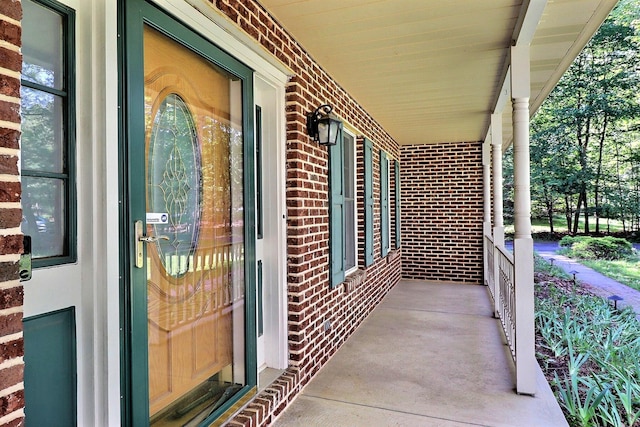 102 Crest Cir E, Stroudsburg, PA 18301 - doorway to property with covered porch and brick siding