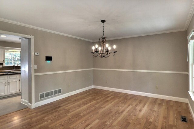 102 Crest Cir E, Stroudsburg, PA 18301 - unfurnished dining area with wood finished floors, a chandelier, and ornamental molding