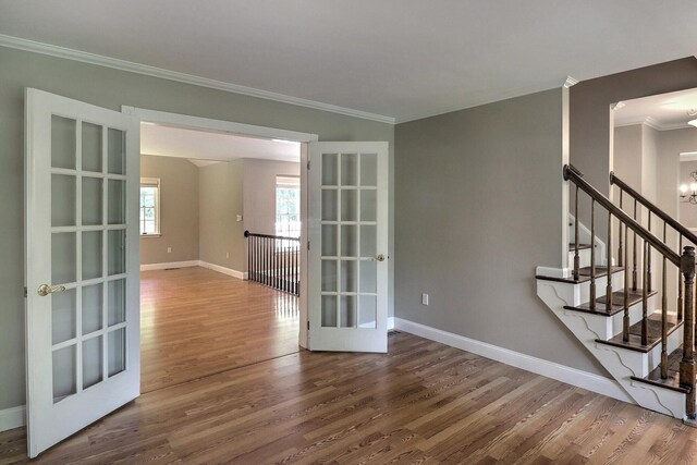 102 Crest Cir E, Stroudsburg, PA 18301 - spare room featuring wood finished floors, ornamental molding, french doors, and stairs