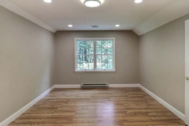 102 Crest Cir E, Stroudsburg, PA 18301 - spare room with baseboard heating, recessed lighting, light wood finished floors, and lofted ceiling