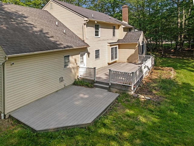 102 Crest Cir E, Stroudsburg, PA 18301 - back of property with a lawn, a wooden deck, a shingled roof, and a chimney