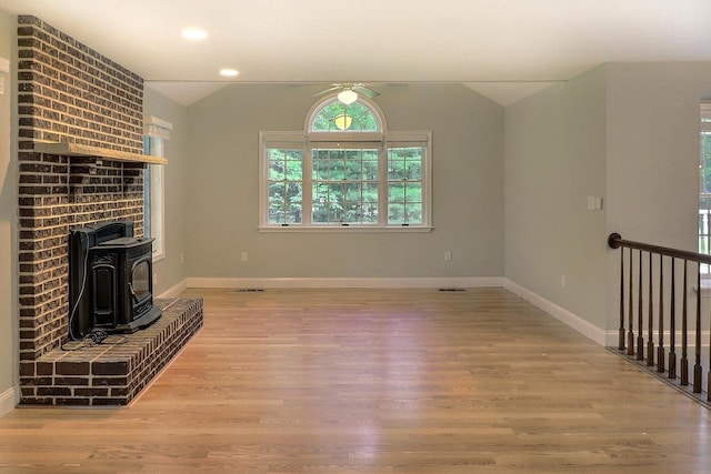 102 Crest Cir E, Stroudsburg, PA 18301 - unfurnished living room featuring vaulted ceiling, wood finished floors, ceiling fan, a wood stove, and recessed lighting