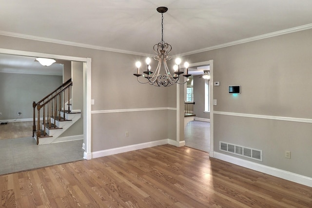 102 Crest Cir E, Stroudsburg, PA 18301 - unfurnished room with a chandelier, wood finished floors, ornamental molding, and stairs