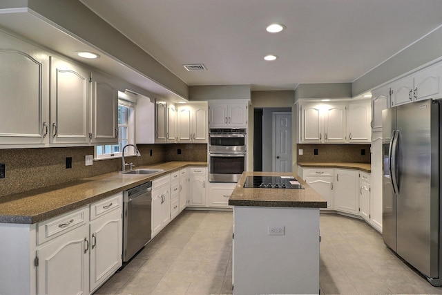 102 Crest Cir E, Stroudsburg, PA 18301 - kitchen with appliances with stainless steel finishes, a kitchen island, recessed lighting, white cabinetry, and dark countertops