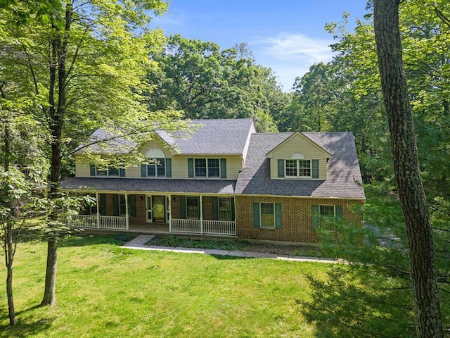 102 Crest Cir E, Stroudsburg, PA 18301 - view of front of property with brick siding, a porch, a front yard, and a shingled roof