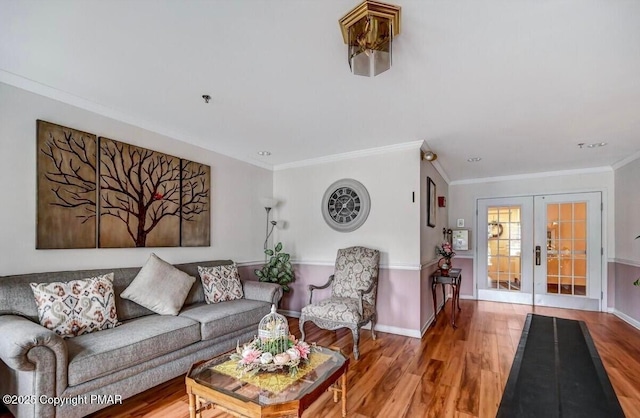 living room with crown molding, wood-type flooring, and french doors