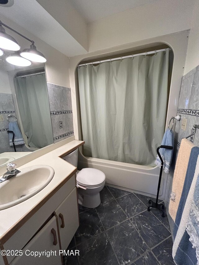 full bathroom featuring vanity, toilet, shower / bath combo, and marble finish floor