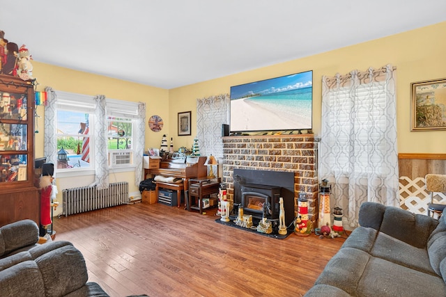 10 S Broad St, Bangor, PA 18013 - living area with radiator, wood finished floors, and a wood stove
