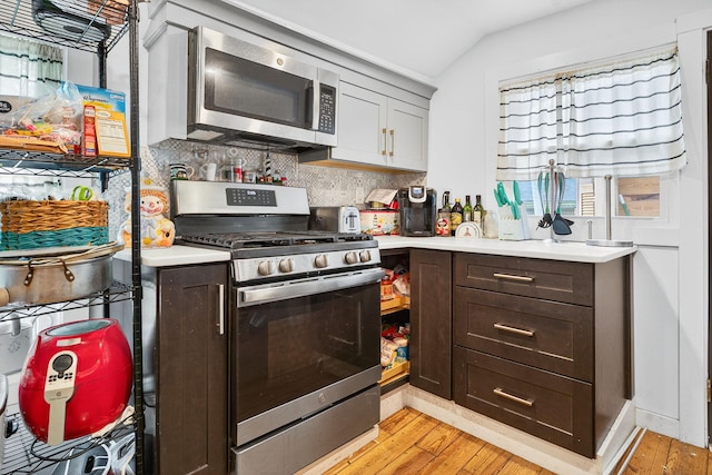 10 S Broad St, Bangor, PA 18013 - kitchen featuring appliances with stainless steel finishes, light wood-type flooring, light countertops, backsplash, and lofted ceiling
