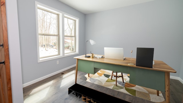 office space featuring baseboards, plenty of natural light, and wood finished floors