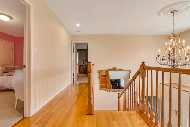 1376 Buck Ridge Dr, Stroudsburg, PA 18360 - hall with an upstairs landing, light wood-style floors, baseboards, and a chandelier