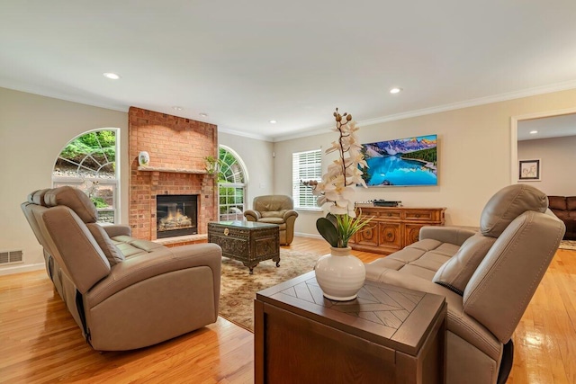 1376 Buck Ridge Dr, Stroudsburg, PA 18360 - living area with light wood-type flooring, a brick fireplace, recessed lighting, crown molding, and baseboards