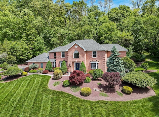 1376 Buck Ridge Dr, Stroudsburg, PA 18360 - view of front facade with brick siding, a front lawn, and roof with shingles
