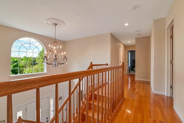 1376 Buck Ridge Dr, Stroudsburg, PA 18360 - hall featuring light wood-type flooring, a chandelier, baseboards, recessed lighting, and an upstairs landing