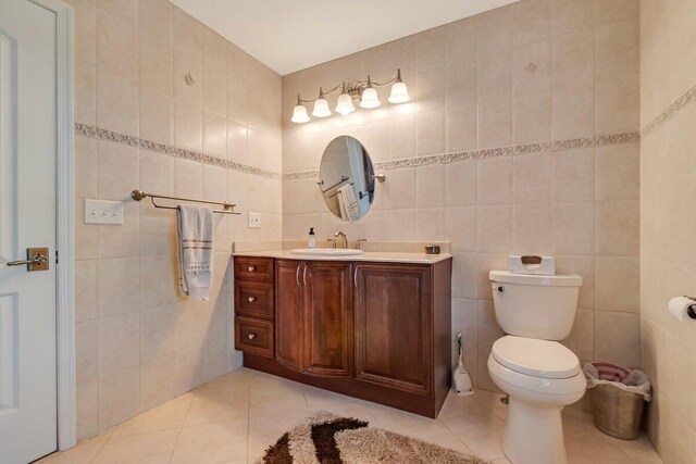 1376 Buck Ridge Dr, Stroudsburg, PA 18360 - bathroom with tile walls, tile patterned flooring, vanity, and toilet