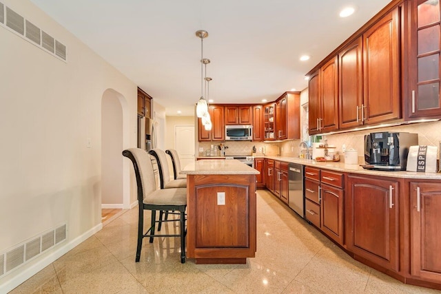 1376 Buck Ridge Dr, Stroudsburg, PA 18360 - kitchen with appliances with stainless steel finishes, recessed lighting, decorative backsplash, glass insert cabinets, and baseboards