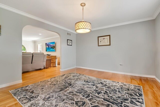 1376 Buck Ridge Dr, Stroudsburg, PA 18360 - spare room featuring arched walkways, ornamental molding, wood finished floors, and baseboards