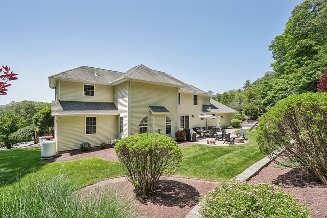 1376 Buck Ridge Dr, Stroudsburg, PA 18360 - rear view of house with a patio, a lawn, and roof with shingles