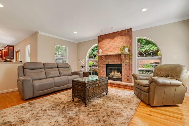 1376 Buck Ridge Dr, Stroudsburg, PA 18360 - living room featuring light wood-style flooring, recessed lighting, ornamental molding, a fireplace, and baseboards