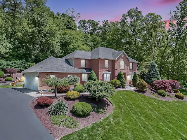 1376 Buck Ridge Dr, Stroudsburg, PA 18360 - view of front facade featuring brick siding, asphalt driveway, a front yard, a garage, and roof with shingles