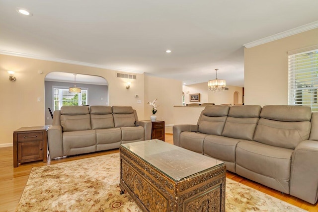 1376 Buck Ridge Dr, Stroudsburg, PA 18360 - living area with arched walkways, ornamental molding, light wood-style flooring, a chandelier, and recessed lighting