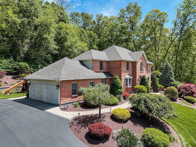 1376 Buck Ridge Dr, Stroudsburg, PA 18360 - view of front of home with brick siding, an attached garage, asphalt driveway, and a shingled roof