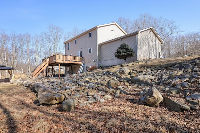 back of house with stairway and a wooden deck