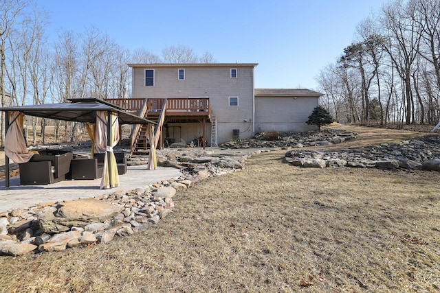 back of house with a wooden deck and stairs