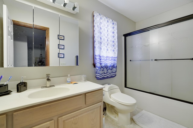 full bath featuring enclosed tub / shower combo, toilet, and vanity