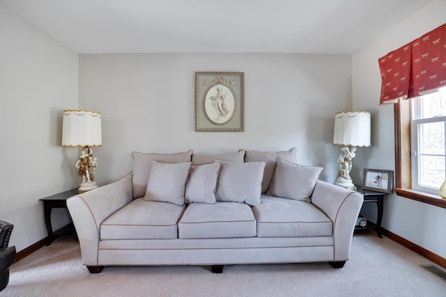 carpeted living room featuring baseboards and visible vents