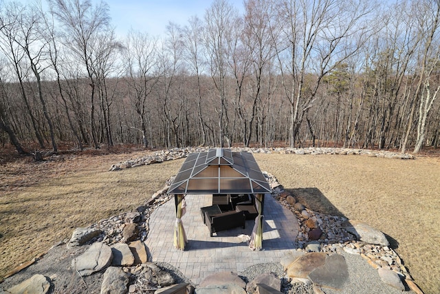 view of patio / terrace with a forest view