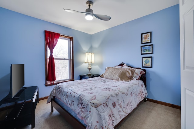 carpeted bedroom with a ceiling fan and baseboards