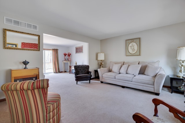 carpeted living area featuring visible vents