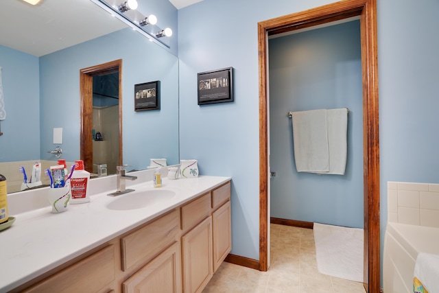 full bathroom with vanity, a bath, baseboards, and tile patterned flooring