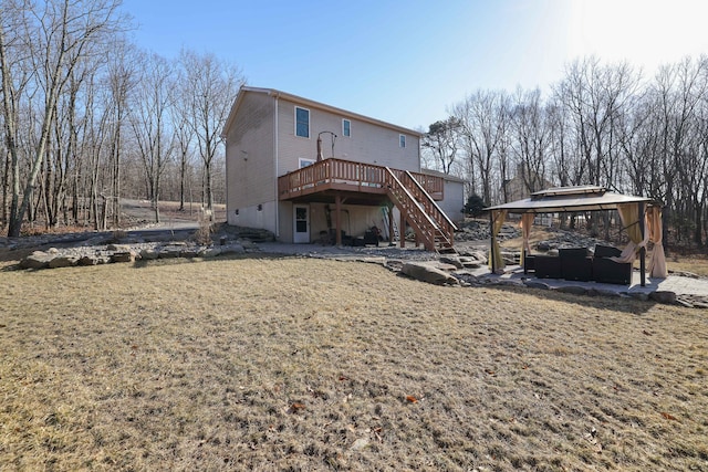 back of house featuring a gazebo, stairway, a lawn, and a wooden deck