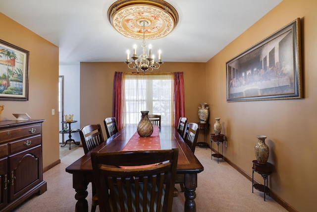 dining area with baseboards, light carpet, and a notable chandelier