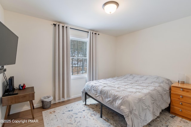 bedroom with hardwood / wood-style flooring