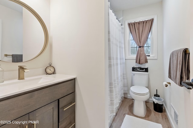 bathroom with vanity, hardwood / wood-style floors, and toilet