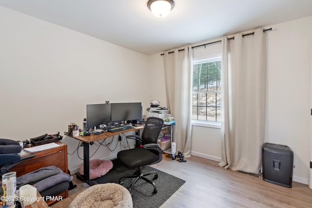 office space with baseboards and wood finished floors