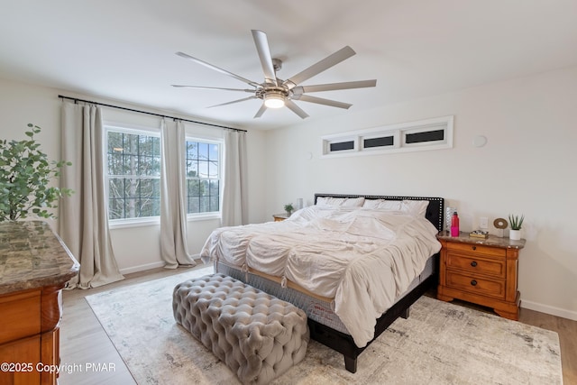 bedroom featuring ceiling fan and light hardwood / wood-style flooring