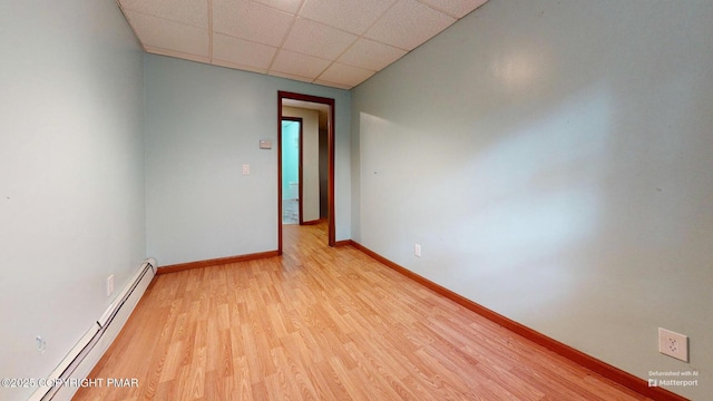 619 Rimrock Rd, Bartonsville, PA 18321 - unfurnished room featuring a baseboard radiator, light wood-type flooring, and a paneled ceiling