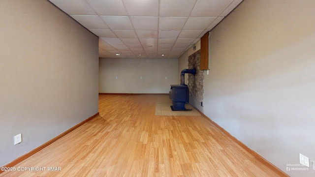 619 Rimrock Rd, Bartonsville, PA 18321 - empty room with wood finished floors, a wood stove, and a drop ceiling