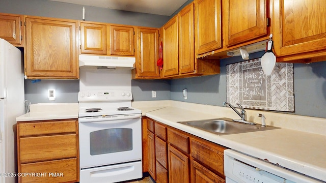 619 Rimrock Rd, Bartonsville, PA 18321 - kitchen with under cabinet range hood, white appliances, light countertops, and brown cabinetry