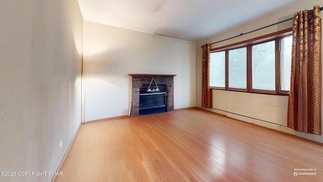 619 Rimrock Rd, Bartonsville, PA 18321 - unfurnished living room featuring a glass covered fireplace and light wood finished floors